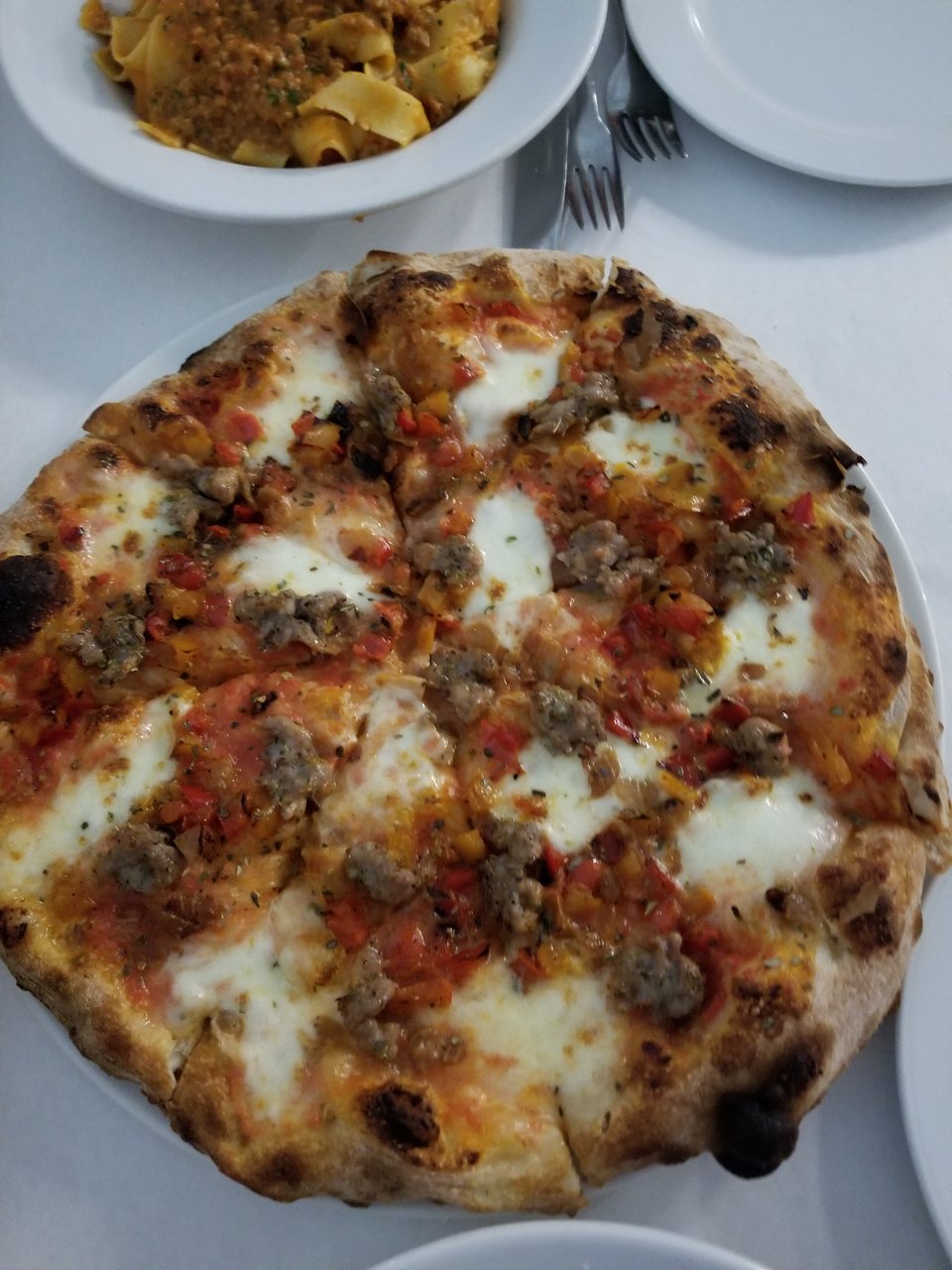 Cantoro Italian Market & Trattoria signature dishes Salsiccia Peperonata Pizza, Veal Ravioli, Ravioli Alla Napoletana.